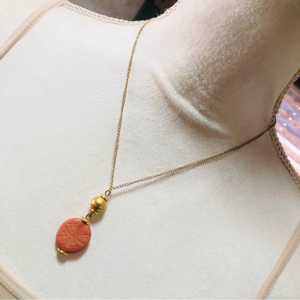 Carved red jasper beaded pendant on chain necklace
